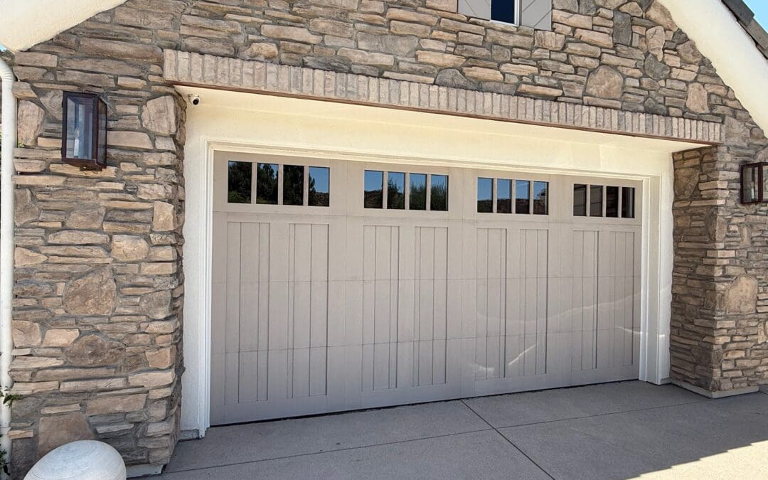 A modern Encino garage door installation by Archway Garage Doors, featuring a matte black Martin Athena aluminum frame with frosted glass to create a sleek San Fernando Valley design.
